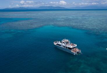 Cairns Charter Boat Sunset Views - Aerial View of tour boat at Upolu Reef on the Great Barrier Reef in Australia 