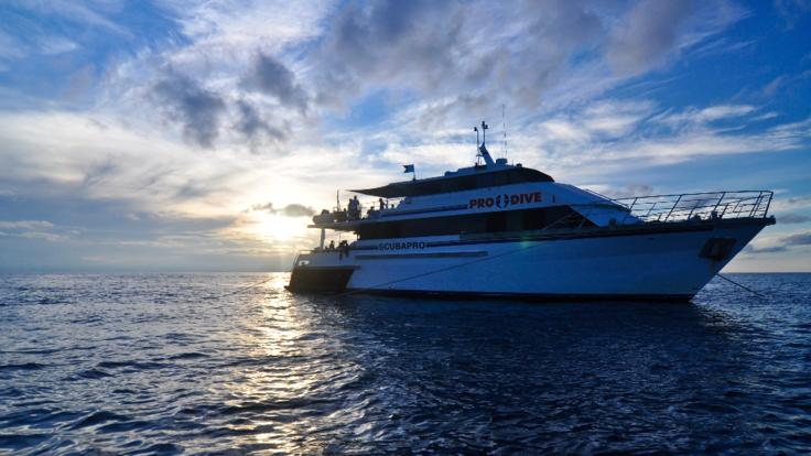 Cairns Dive Courses - Dive boat at anchor and sunset on the Great Barrier Reef
