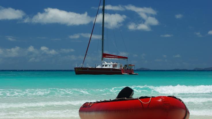 Take a tender ride to Whitehaven Beach from the yacht 