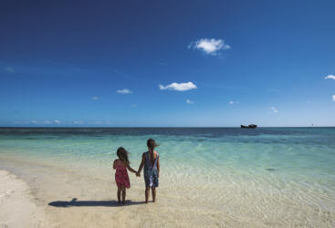 Kids enjoying the pristine beach and water on Heron Island, Great Barrier Reef